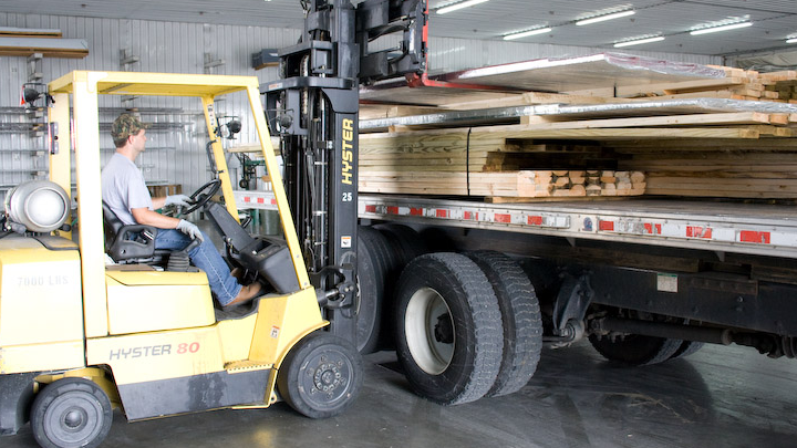 man loading delivery truck with building materials