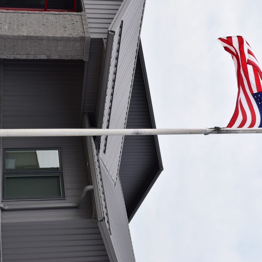 american flag outside post frame building