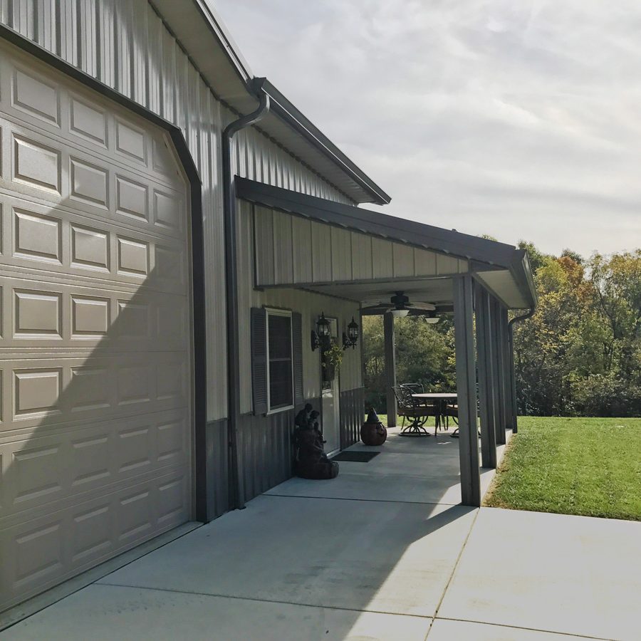 metal overhang over small patio attached to garage