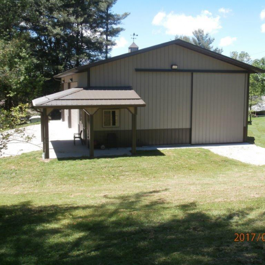 tan metal sided post frame building