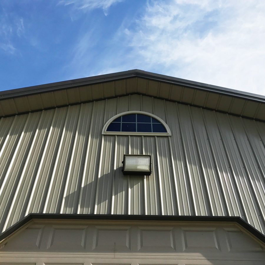 tan metal overhang and small half moon window