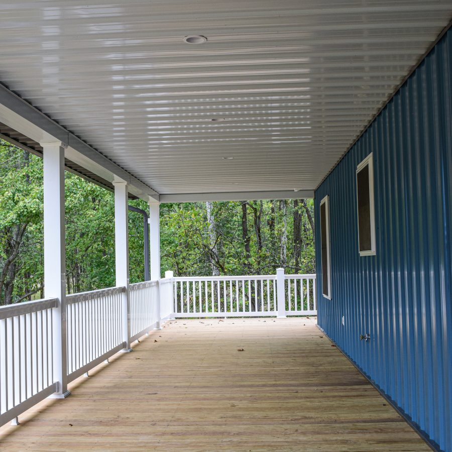 wooden porch and railing attached to new building