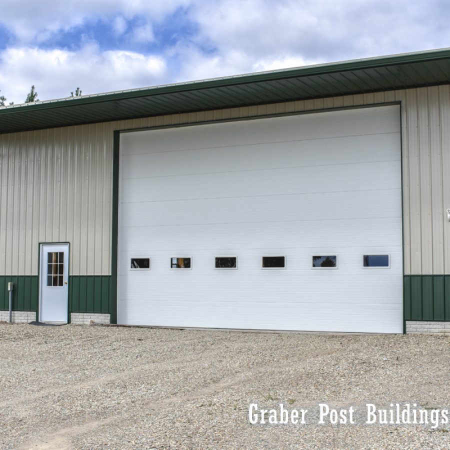 tan and green metal sided post frame buildling