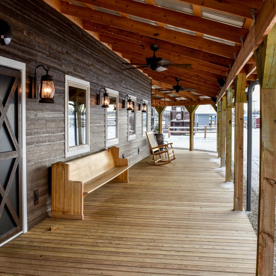 attached wooden deck wtih overhang on store